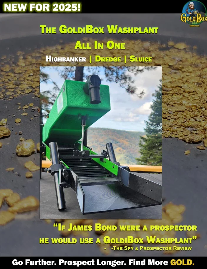 A green dump truck is parked on the side of a road.